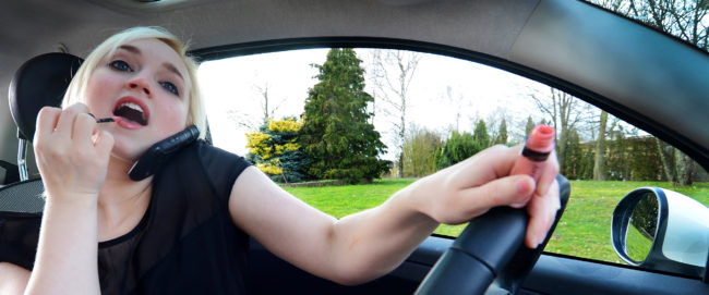 Distracted Driving Woman Putting on LIipstick